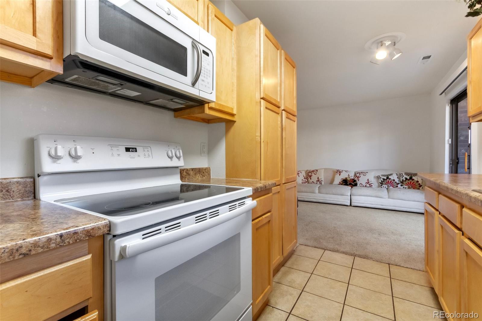 2265 South Buckley Road, Unit 102 Aurora, CO 80013 - Photo 14 of 28 a kitchen with a stove and a microwave