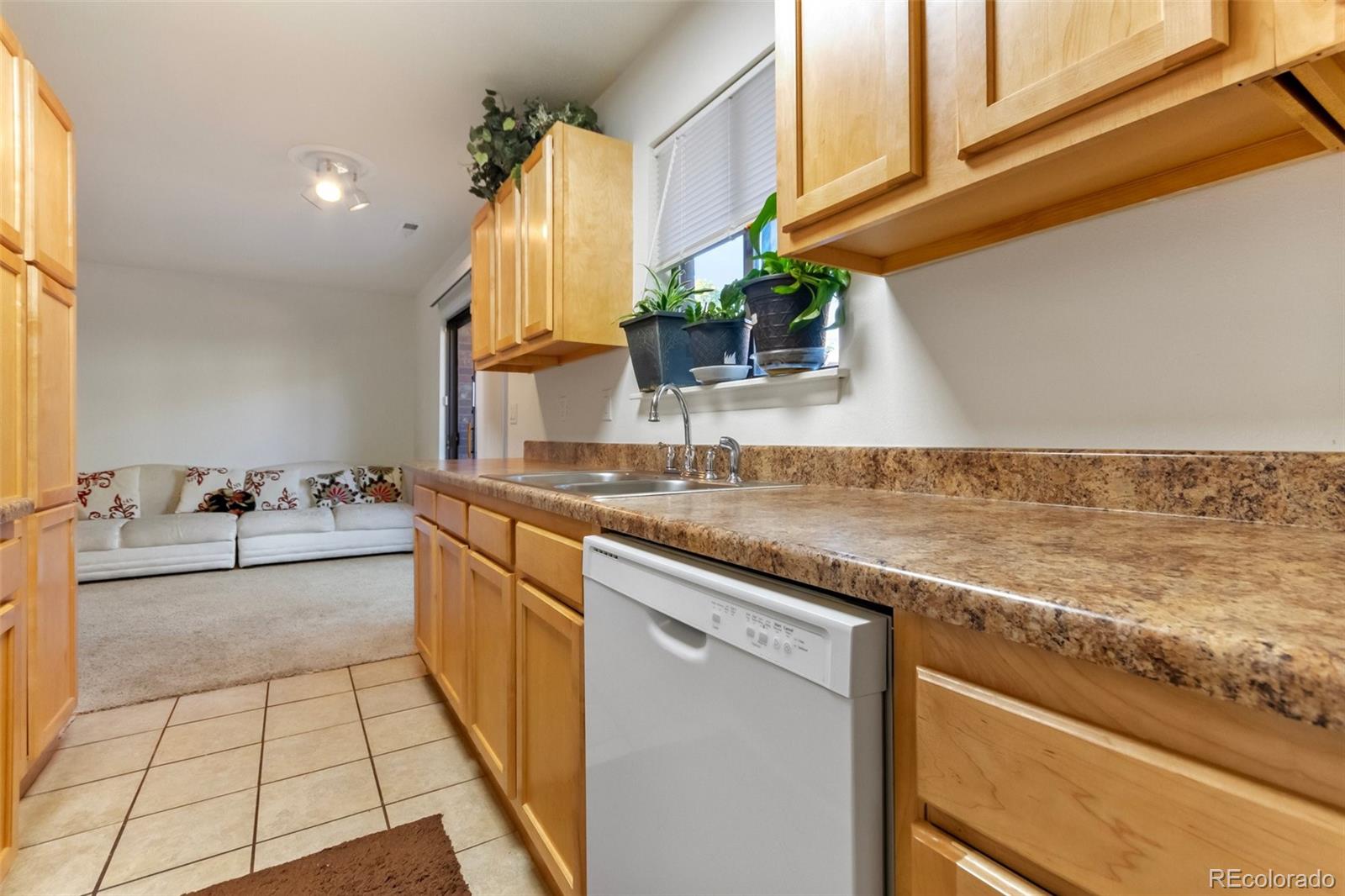 2265 South Buckley Road, Unit 102 Aurora, CO 80013 - Photo 15 of 28 a kitchen with stainless steel appliances granite countertop a sink and cabinets
