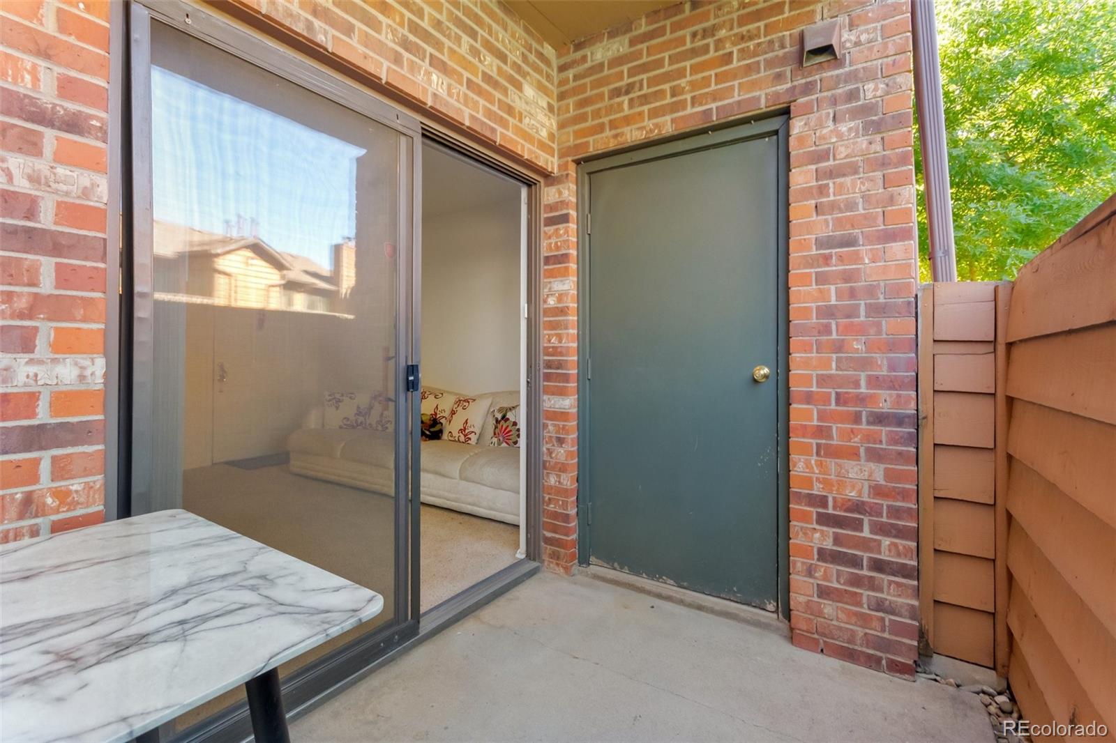 2265 South Buckley Road, Unit 102 Aurora, CO 80013 - Photo 19 of 28 a view of a porch with a table and chair