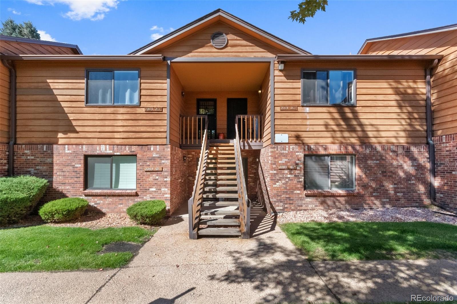 2265 South Buckley Road, Unit 102 Aurora, CO 80013 - Photo 2 of 28 a front view of a house with a yard