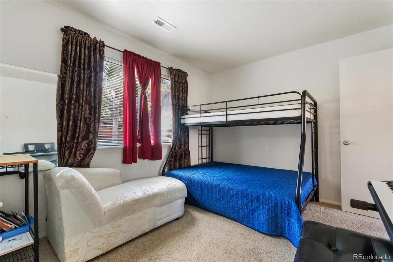 2265 South Buckley Road, Unit 102 Aurora, CO 80013 - Photo 22 of 28 a living room with furniture and a window