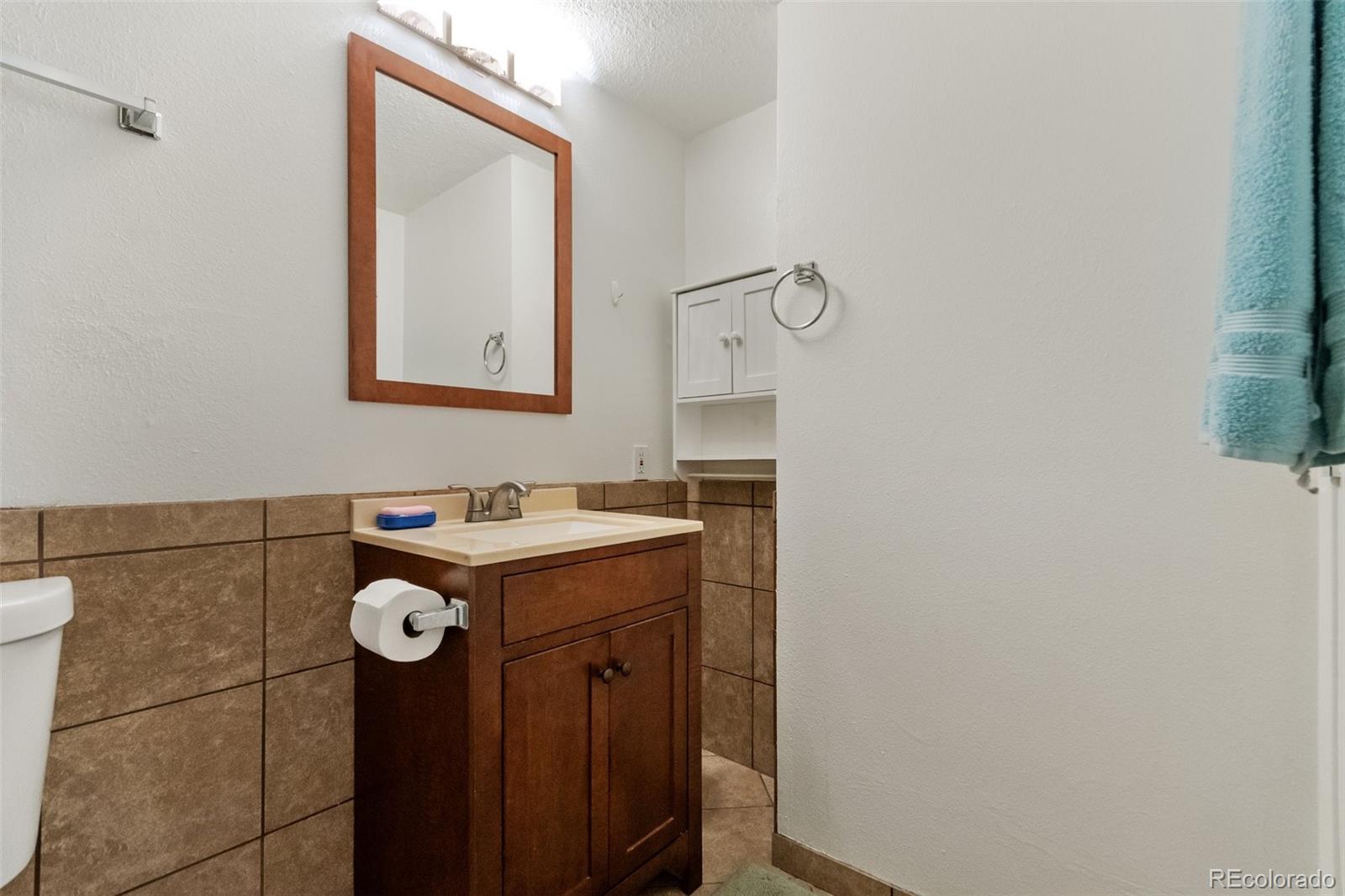 2265 South Buckley Road, Unit 102 Aurora, CO 80013 - Photo 24 of 28 a bathroom with a sink and mirror