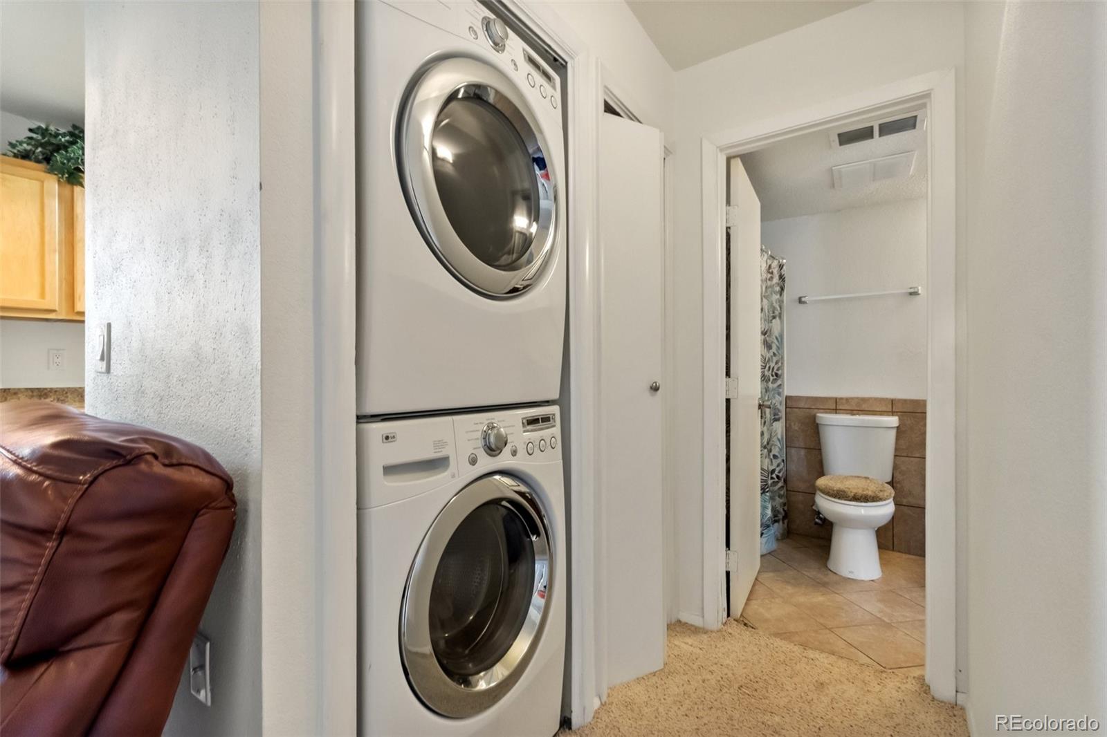 2265 South Buckley Road, Unit 102 Aurora, CO 80013 - Photo 25 of 28 a view of a hallway with washer and dryer