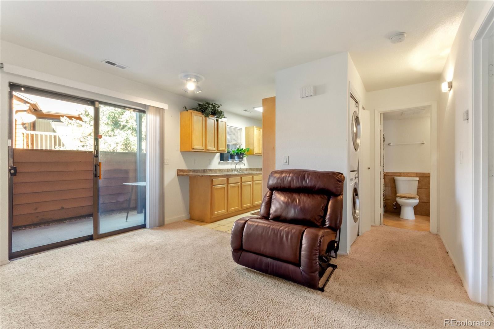 2265 South Buckley Road, Unit 102 Aurora, CO 80013 - Photo 6 of 28 a living room with furniture and a closet