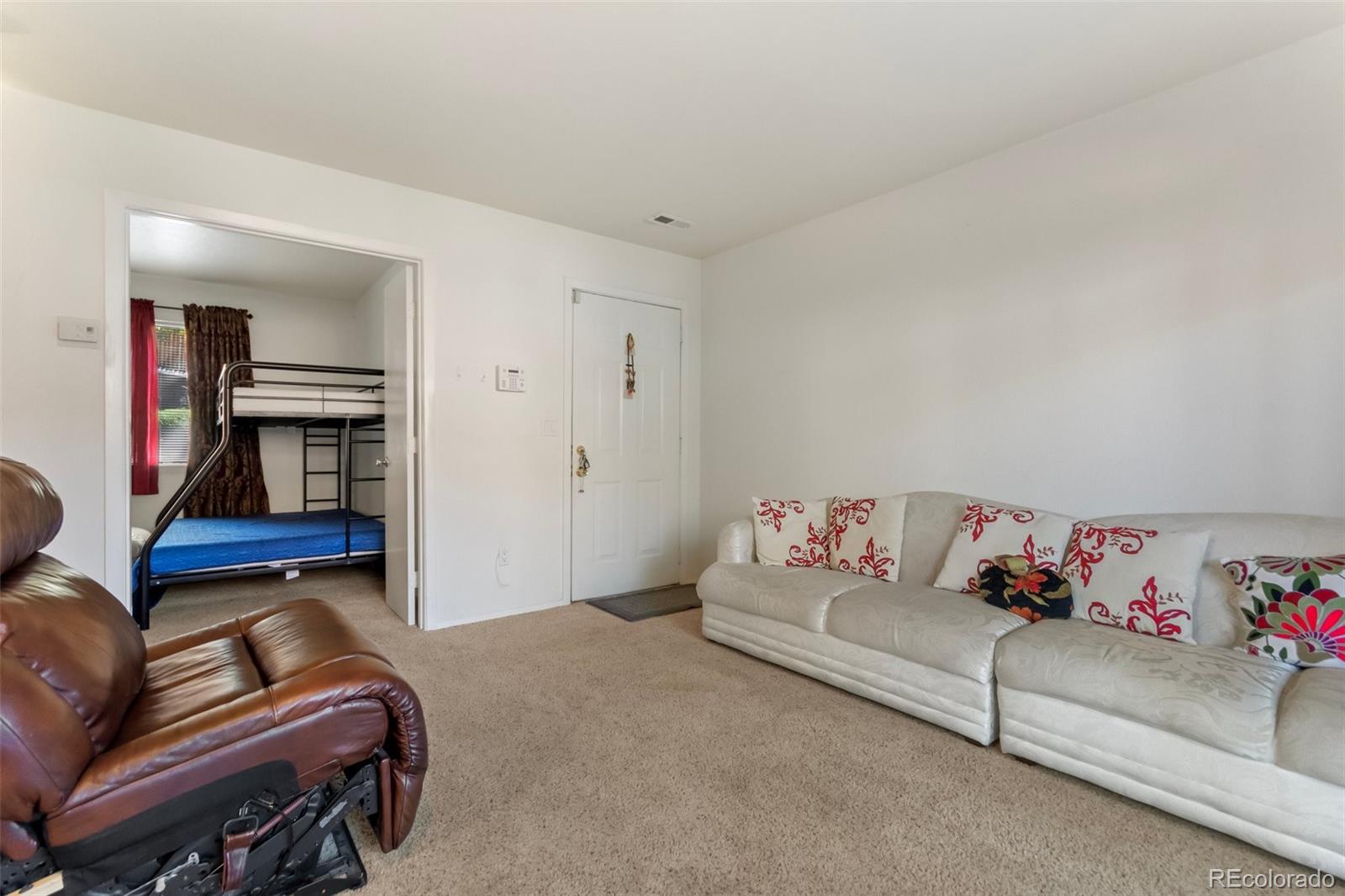 2265 South Buckley Road, Unit 102 Aurora, CO 80013 - Photo 8 of 28 a living room with furniture and a couch