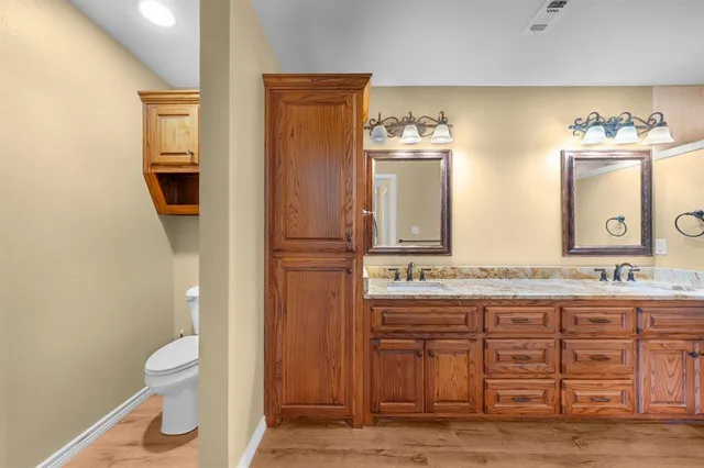 a bathroom with a double vanity sink and a mirror