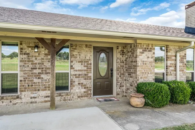 a front view of a building with potted plants