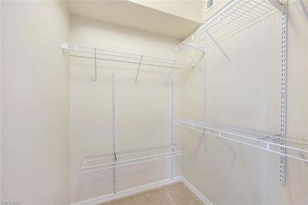 23711 Old Port Road, Unit 101 Estero, FL 34135 - Photo 17 of 30 Walk in closet with carpet floors
