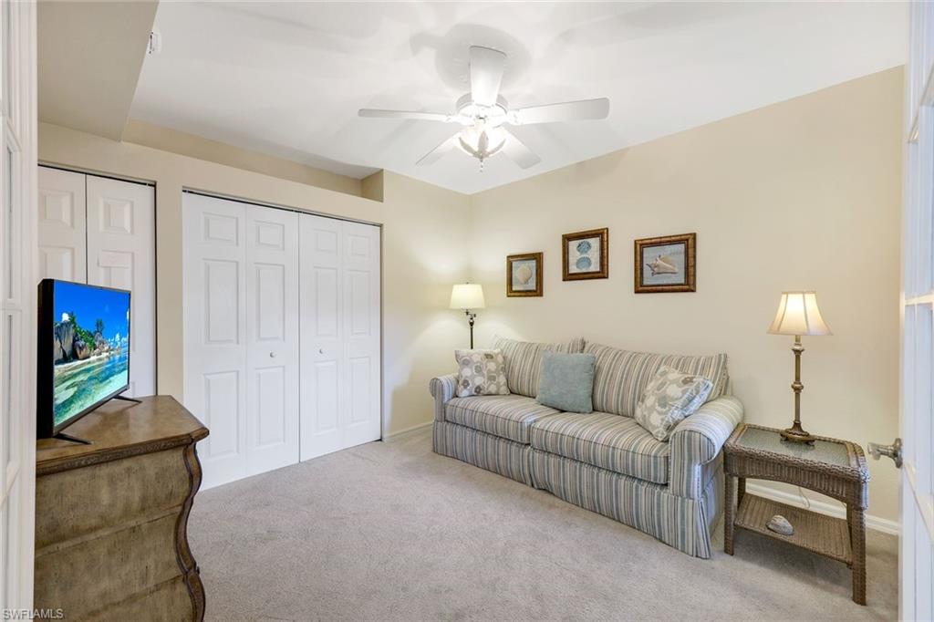 23711 Old Port Road, Unit 101 Estero, FL 34135 - Photo 21 of 30 Carpeted living room with ceiling fan