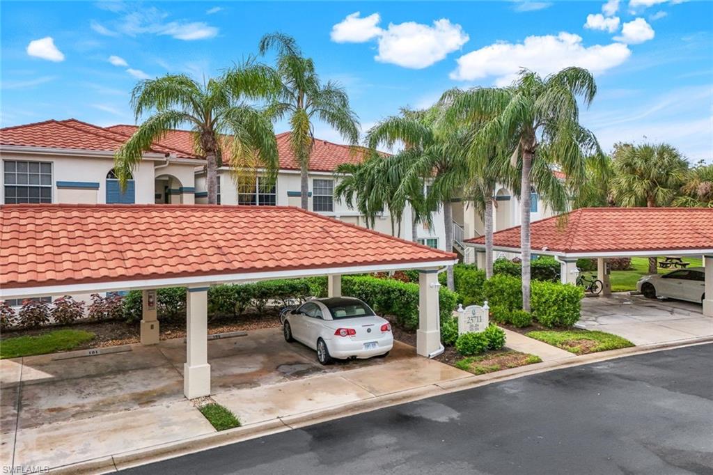 23711 Old Port Road, Unit 101 Estero, FL 34135 - Photo 25 of 30 View of car parking with a carport