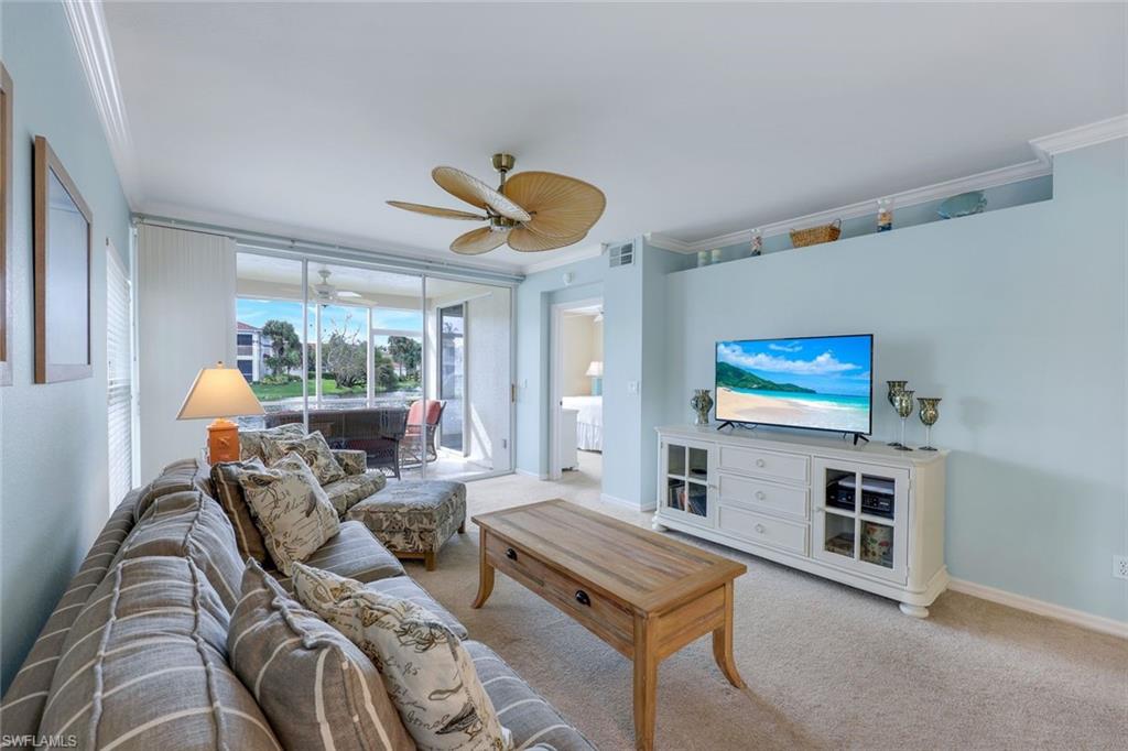 23711 Old Port Road, Unit 101 Estero, FL 34135 - Photo 7 of 30 Living room featuring ornamental molding, light colored carpet, and ceiling fan