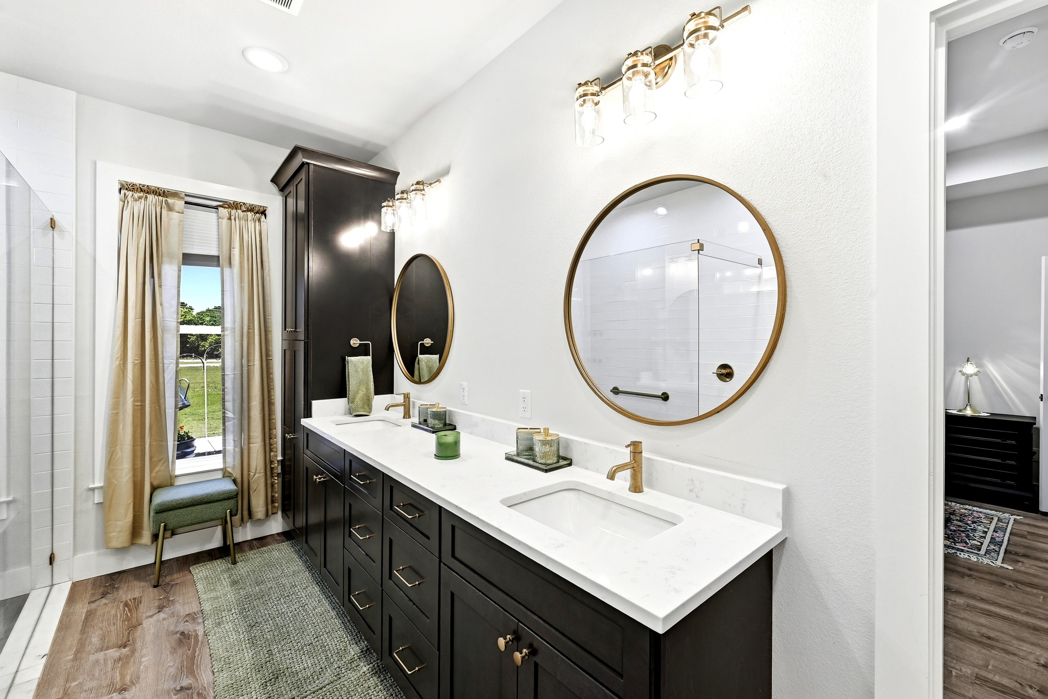 2889 Old McMahan Road Lockhart, TX 78644 - Photo 20 of 33 Dual vanities with quartz countertops and chic fixtures elevate this serene primary bathroom.