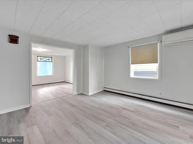 an empty room with windows and closet