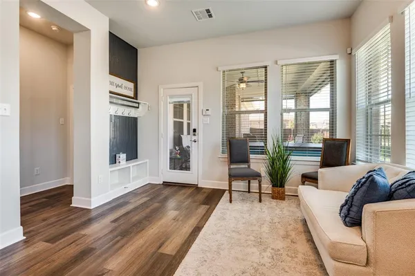 a living room with furniture and a floor to ceiling window