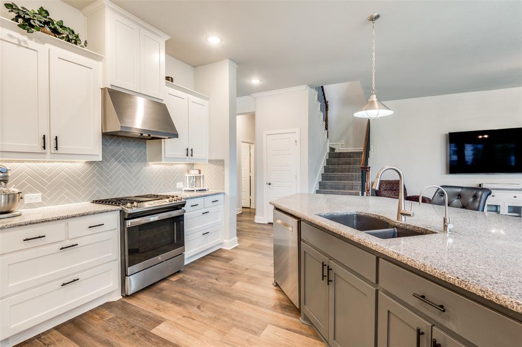 4724 Raspberry Spar Court Arlington, TX 76005 - Photo 16 of 30 a kitchen with granite countertop a sink stainless steel appliances and cabinets