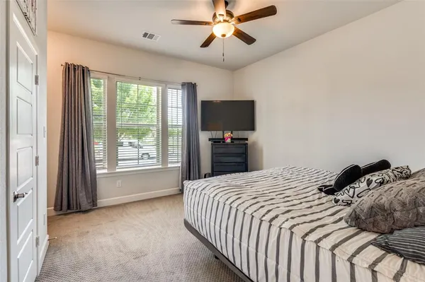 a bedroom with a bed and a flat tv screen
