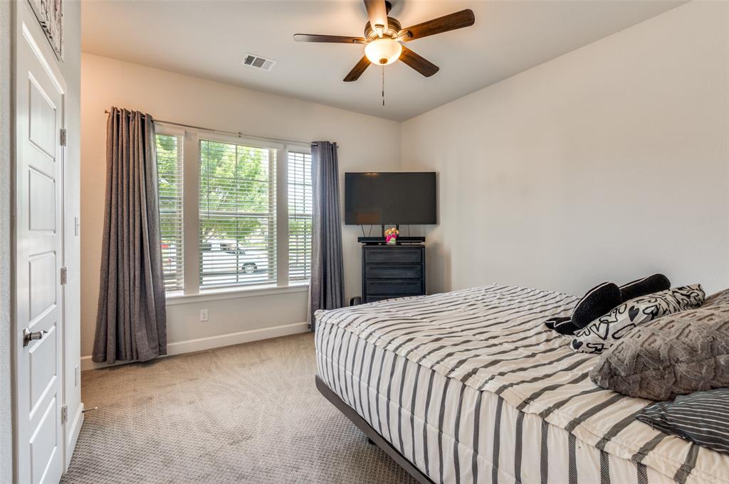 4724 Raspberry Spar Court Arlington, TX 76005 - Photo 18 of 30 a bedroom with a bed and a flat tv screen