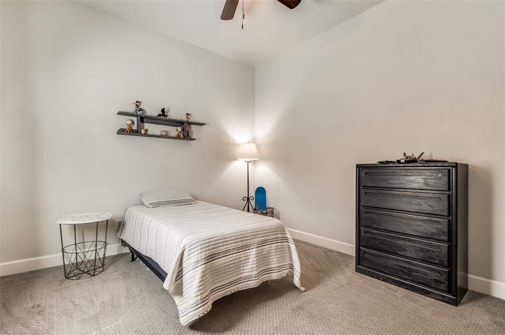 4724 Raspberry Spar Court Arlington, TX 76005 - Photo 20 of 30 a bedroom with a bed and a chandelier