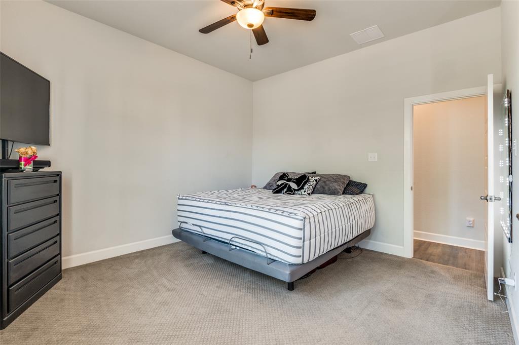 4724 Raspberry Spar Court Arlington, TX 76005 - Photo 21 of 30 a bedroom with a bed and a chandelier