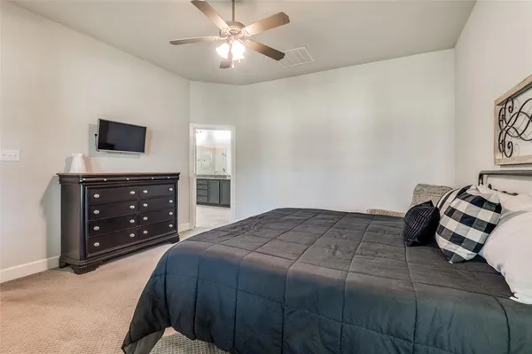 a bedroom with a bed and a tv