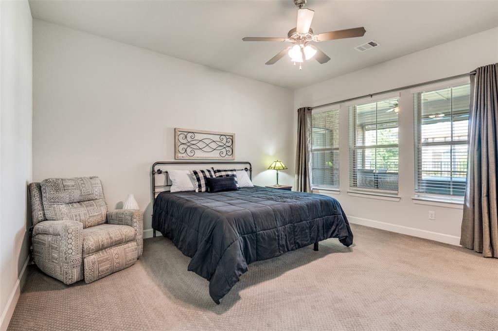 4724 Raspberry Spar Court Arlington, TX 76005 - Photo 23 of 30 a spacious bedroom with a bed and a couch