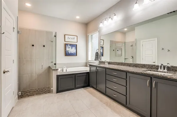 a spacious bathroom with a granite countertop sink and mirror