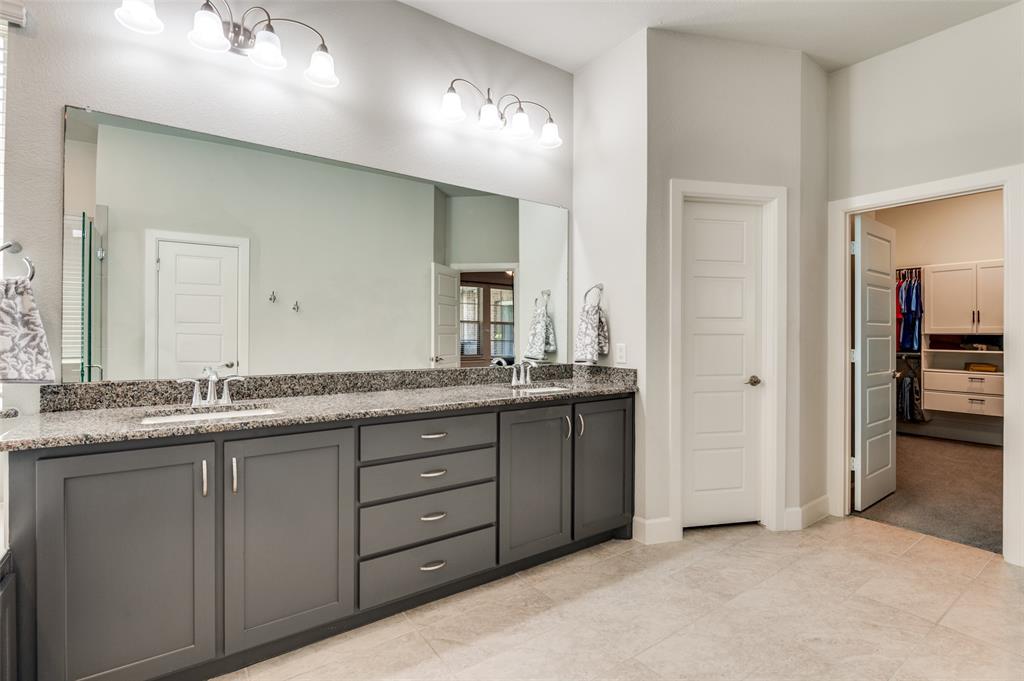 4724 Raspberry Spar Court Arlington, TX 76005 - Photo 25 of 30 a bathroom with double sink and a mirror
