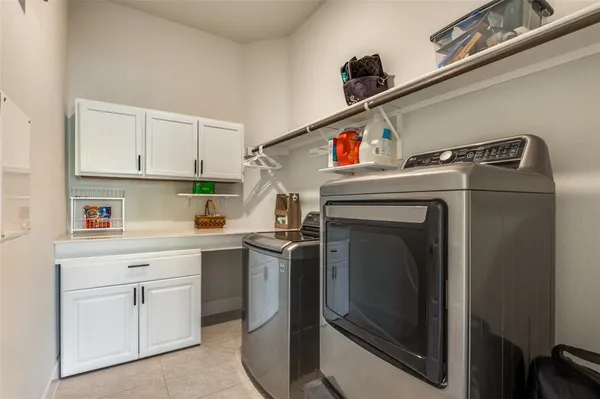 a utility room with sink dryer and washer