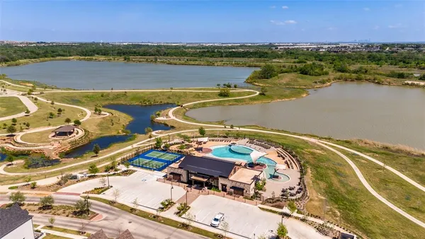 an aerial view of residential houses with outdoor space and river