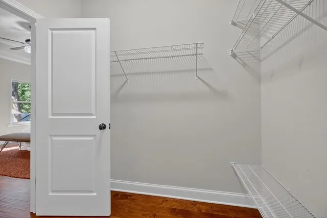 a view of walk in closet with empty racks