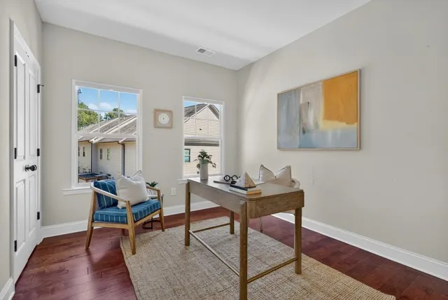 a living room with furniture a rug and a wooden floor