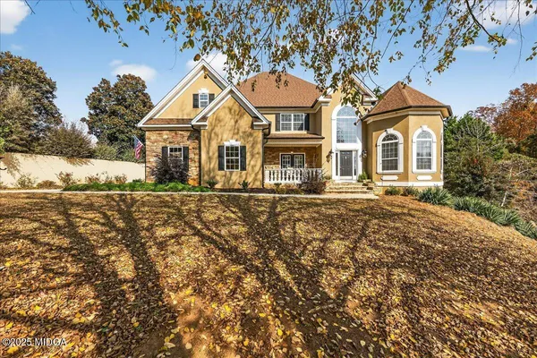 a front view of a house with a yard