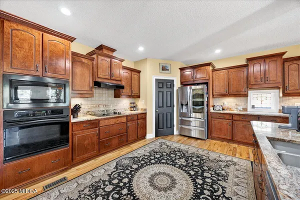 a living room with furniture and kitchen view