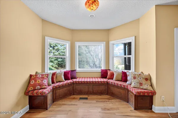 a view of a living room with furniture and a fireplace