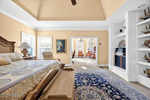 a room with pool table and windows