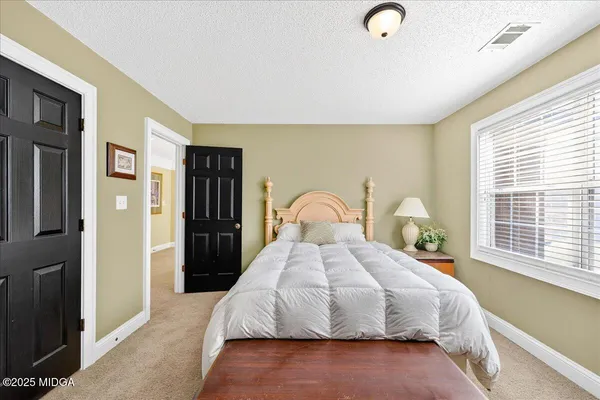 a large kitchen with a sink and cabinets