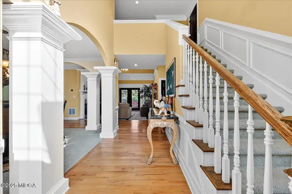 a view of entryway and hall with wooden floor