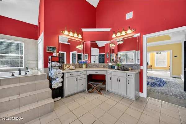 an aerial view of a house with a yard and lake view