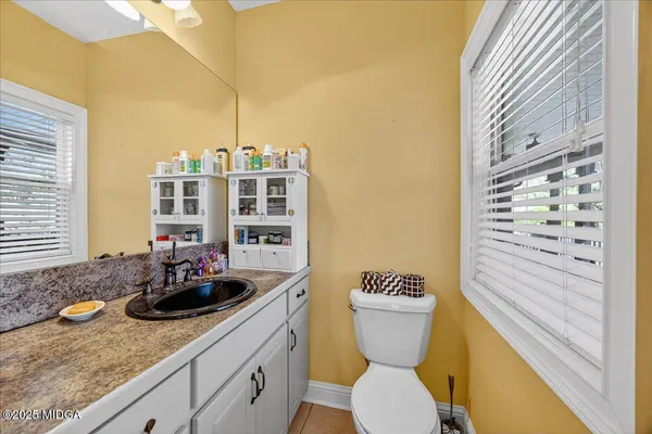 an aerial view of a house with a yard and lake view