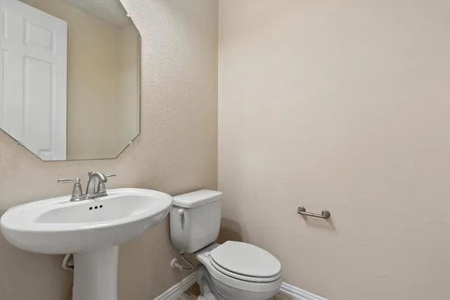 a kitchen with white cabinets and appliances