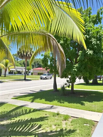a view of swimming pool with a garden and trees