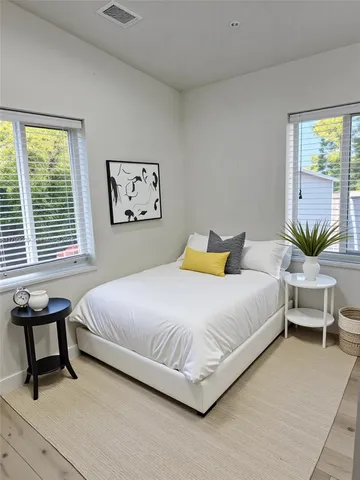 a bedroom with a bed and a couch