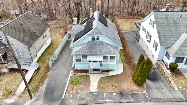 an aerial view of a house with a yard