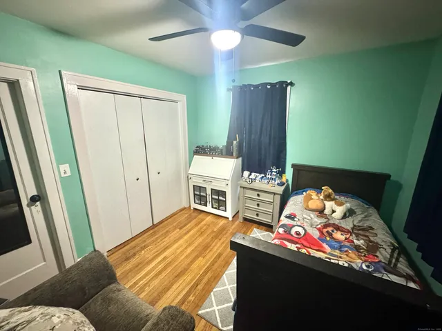 a bed room with a bed window and a chair