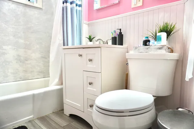 a bathroom with a sink mirror vanity and toilet