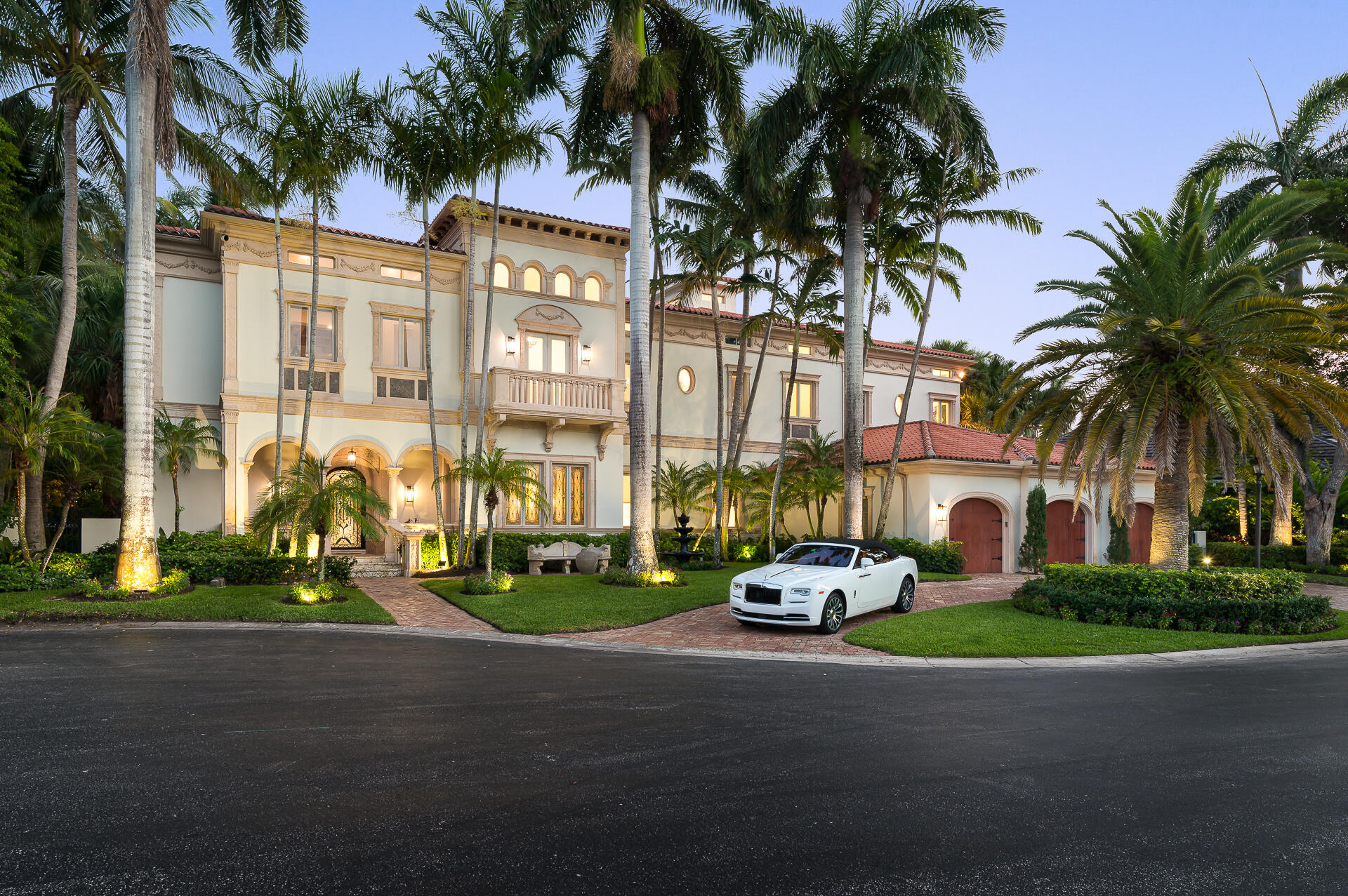700 Northeast 45th Road Boca Raton, FL 33431 - Photo 1 of 62 a car parked in front of a brick house with a yard