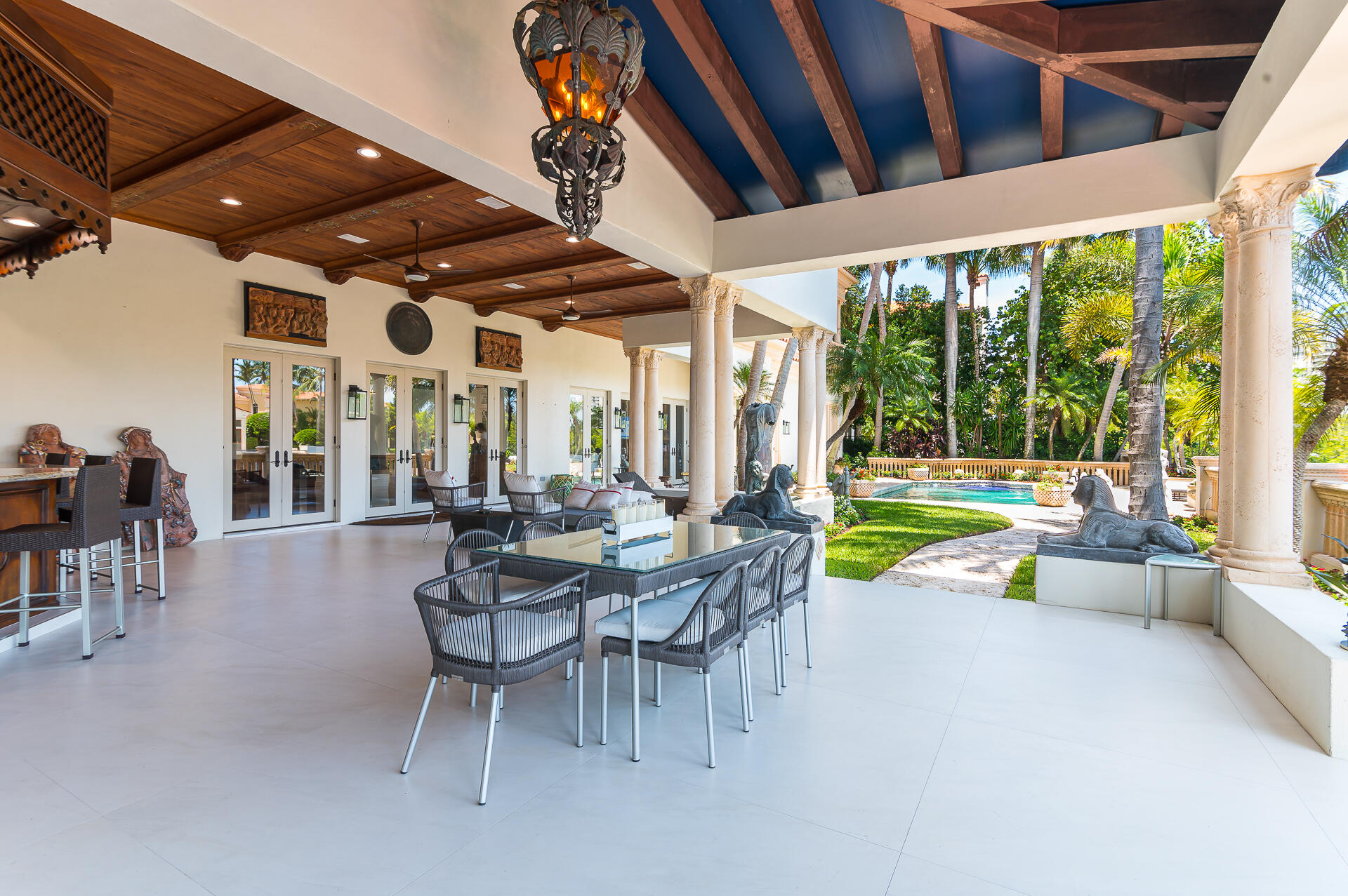 700 Northeast 45th Road Boca Raton, FL 33431 - Photo 24 of 62 a view of a patio with a table and chairs and floor to ceiling window