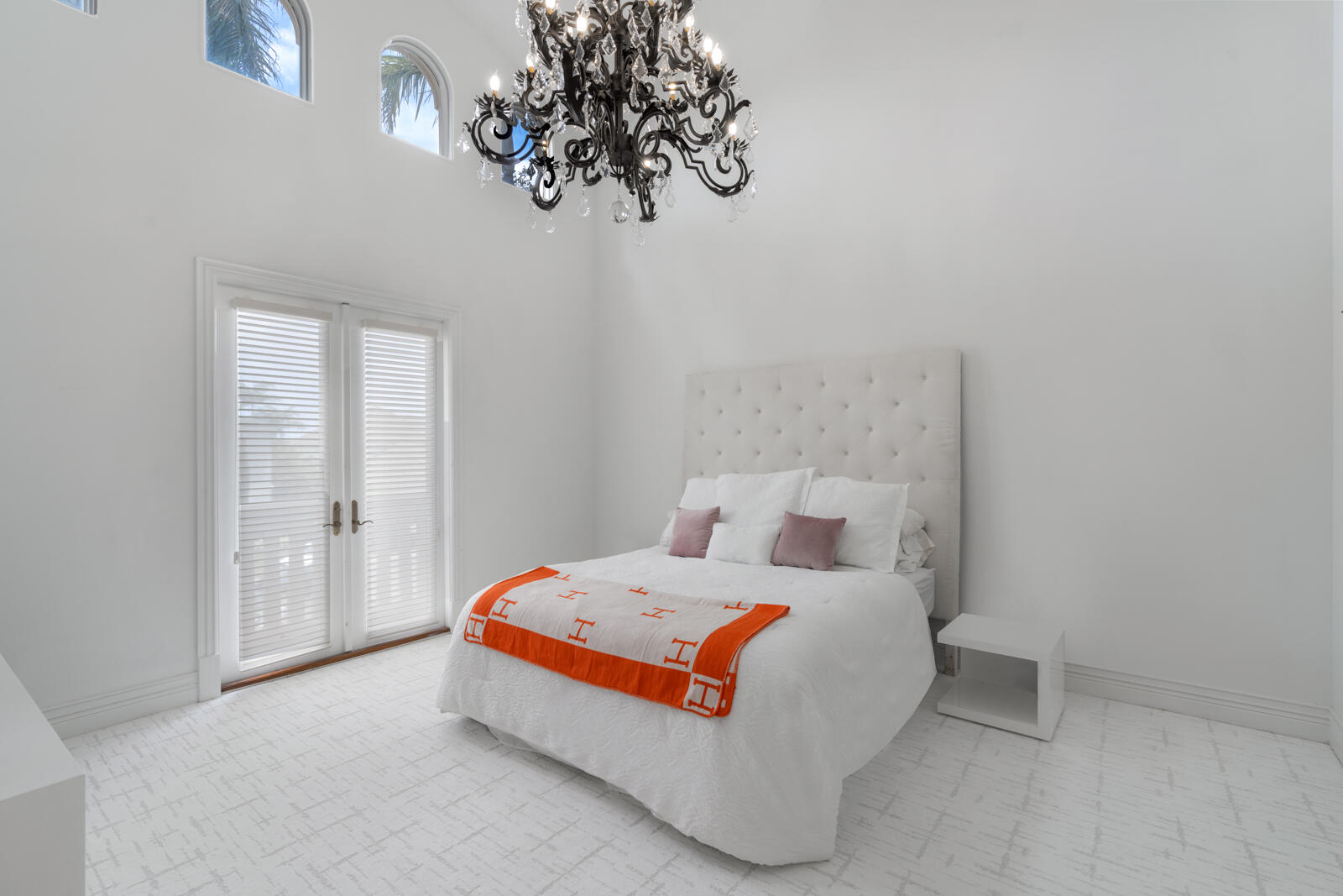 700 Northeast 45th Road Boca Raton, FL 33431 - Photo 37 of 62 a bedroom with a bed and a chandelier