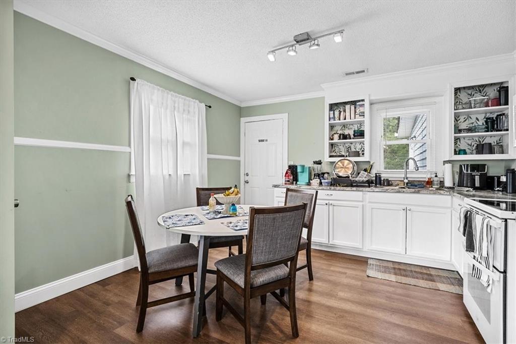 226 Friendly Avenue High Point, NC 27260 - Photo 12 of 38 Another view of the dining area, with a door leading toward the rear of the home and plenty of natural light.