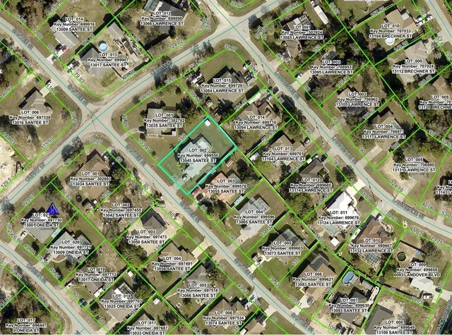 an aerial view of a multi story building with yard